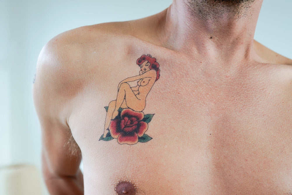 A person with a Redhead Pin-up Girl on a Red Rose temporary tattoo on their chest