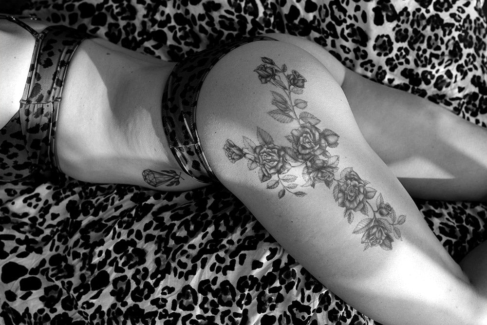 Black roses temporary tattoo on a person's thigh and buttock