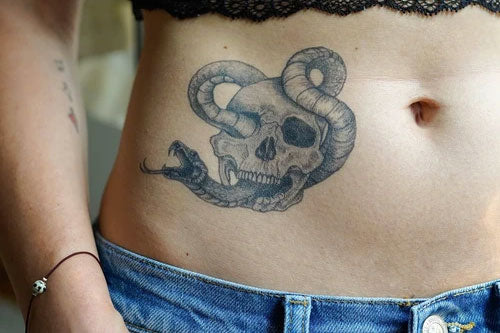 skull tattoo on a belly