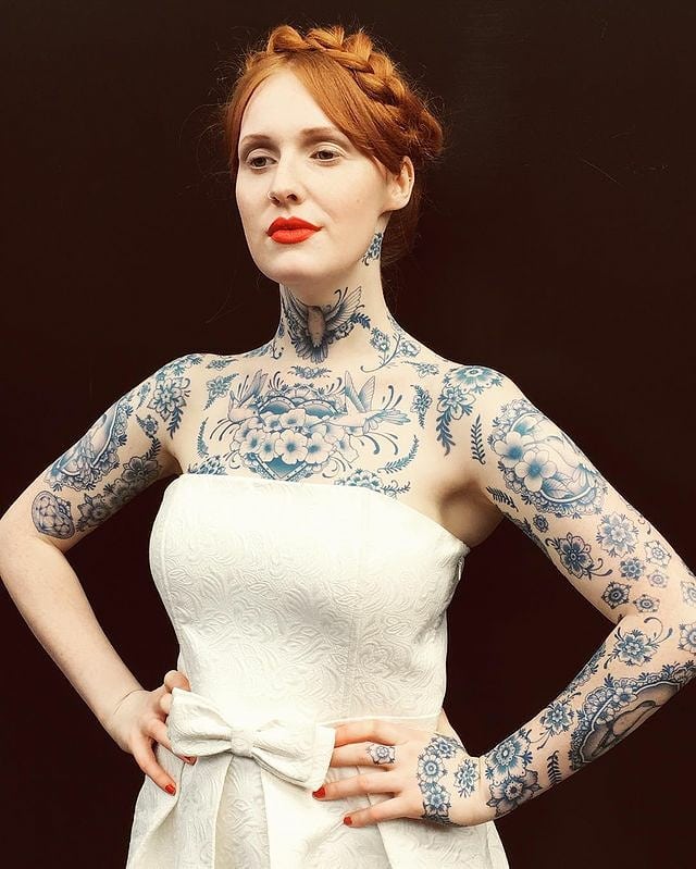a woman with a tattoo on her arms and upper body