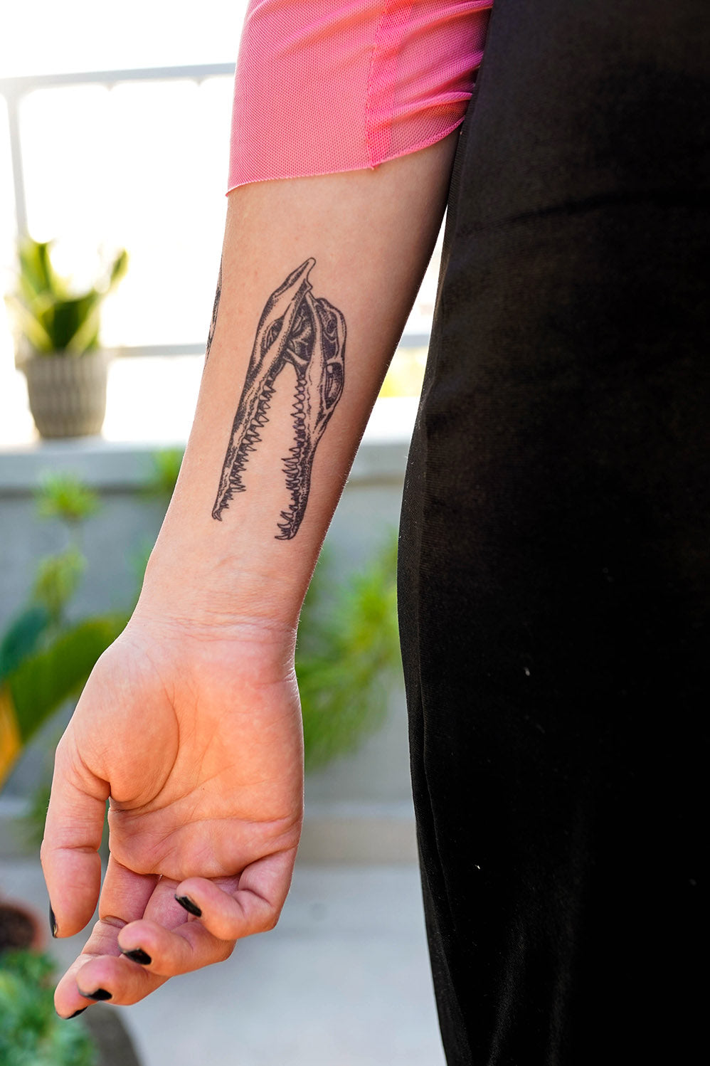 A person with an Alligator Skull Dotwork temporary tattoo on their forearm