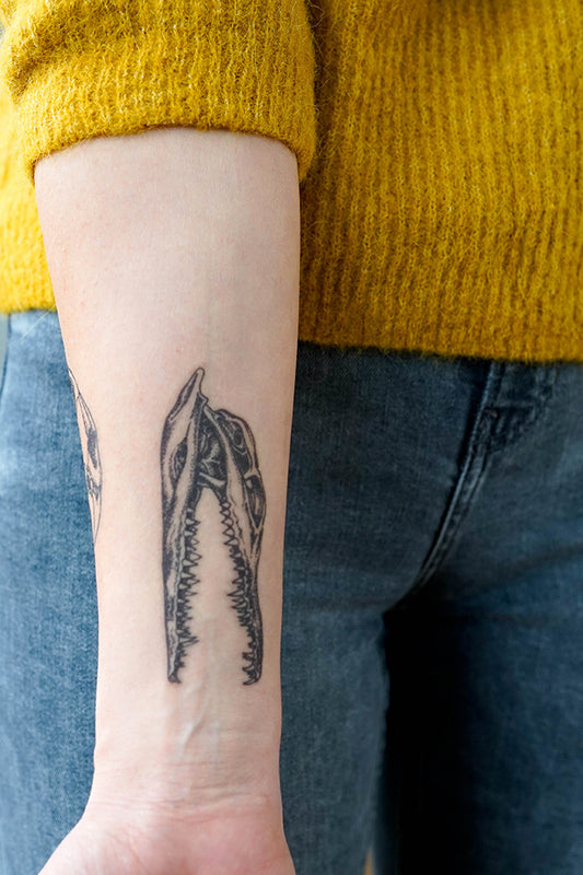 A person showing off a high-quality Alligator Skull Dotwork temporary tattoo on their forearm