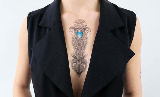 Person with a blue stone ornament tattoo on the chest