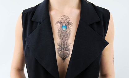 Person with a blue stone ornament tattoo on the chest