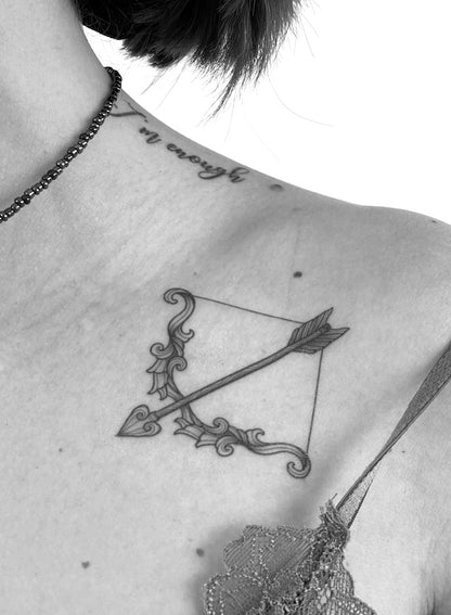 Realistic temporary bow and arrow tattoo on the side of the neck