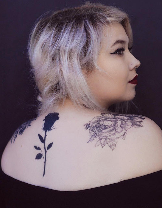 black rose tattoo on girls back