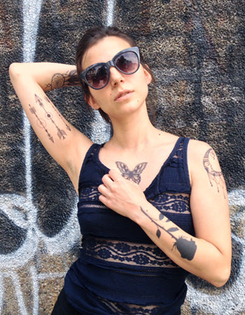 black rose tattoo on girls arm