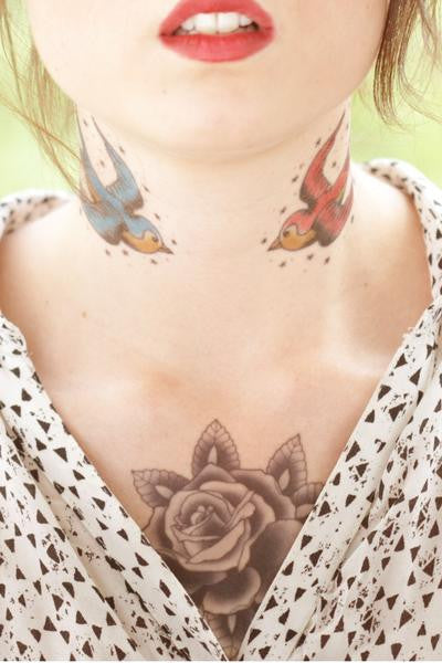 traditional swallow tattoo ,swallows and stars tattoo, tattooed girl with swallows on neck